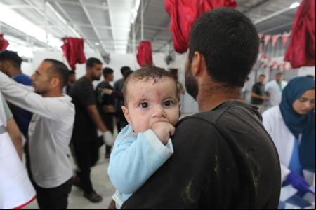 JABALIA, GAZA - MAY 19: An injured baby is seen as the bodies of those lost their lives and the injured in the attack carried out by the Israeli army on the 'Al Hassayna' school d with the United Nations Relief and Works Agency for Palestine Refugees in the Near East (UNRWA) and sheltering displaced people in the Nuseirat Refugee Camp in the central Gaza Strip are being brought to Al-Awda Hospital in Jabalia, Gaza on May 19, 2025. (Photo by Moiz Salhi/Anadolu via Getty Images)